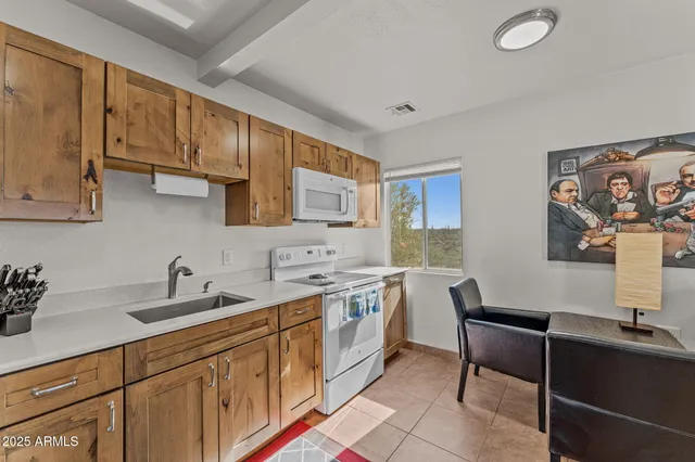 a kitchen with a sink cabinets and window