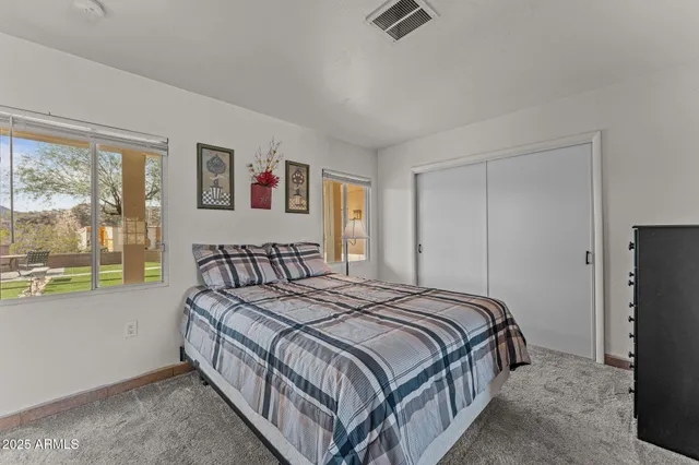 a bedroom with a bed a couch and a window