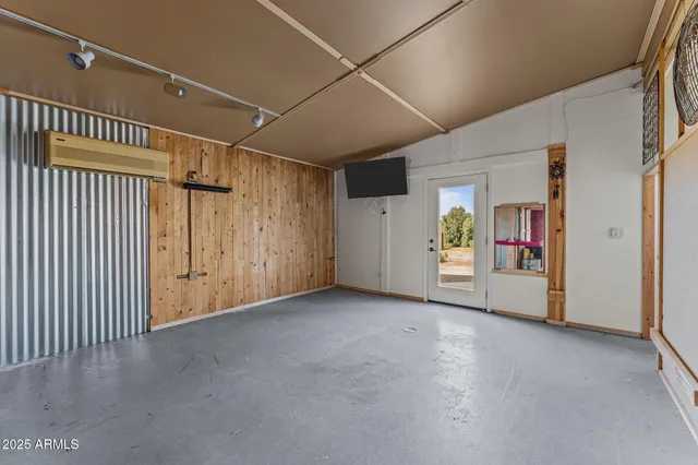 a view of a livingroom with wooden floor and cabinet
