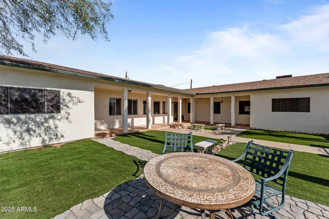 a large kitchen with a table and chairs