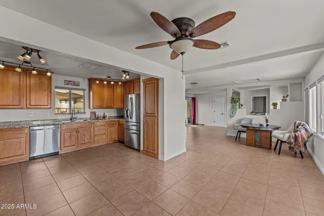 a kitchen with stainless steel appliances granite countertop a sink stove and cabinets