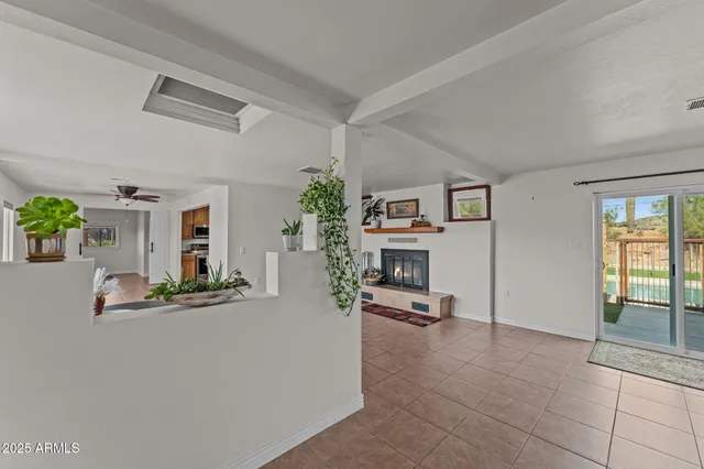 a large kitchen with a window and stainless steel appliances