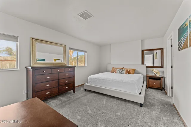 a bedroom with a bed and a dresser