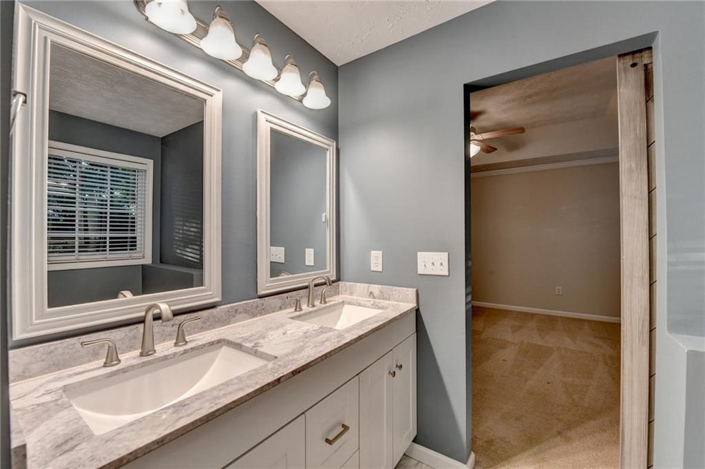 310 Andrew Ridge Drive Jefferson, GA 30549 - Photo 38 of 52 a bathroom with a granite countertop sink and a mirror