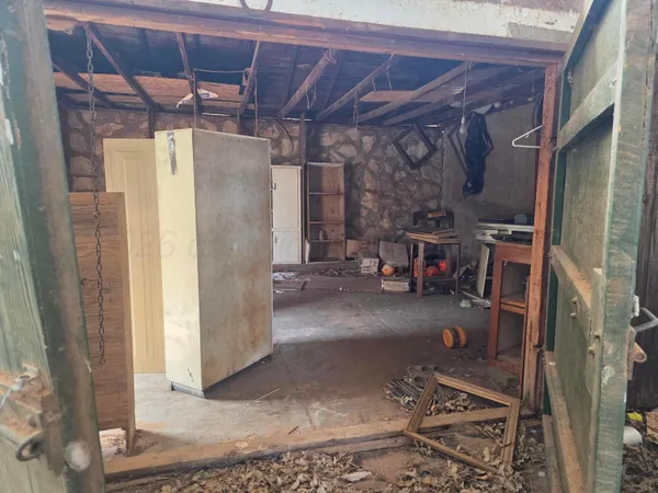 a view of house with yard and sitting area
