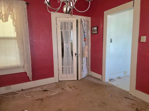 an empty room with a fireplace and fan