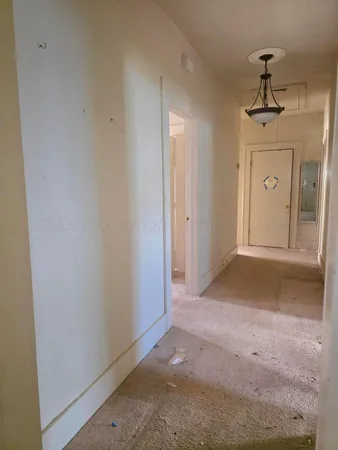 a view of a room with wooden floor and windows