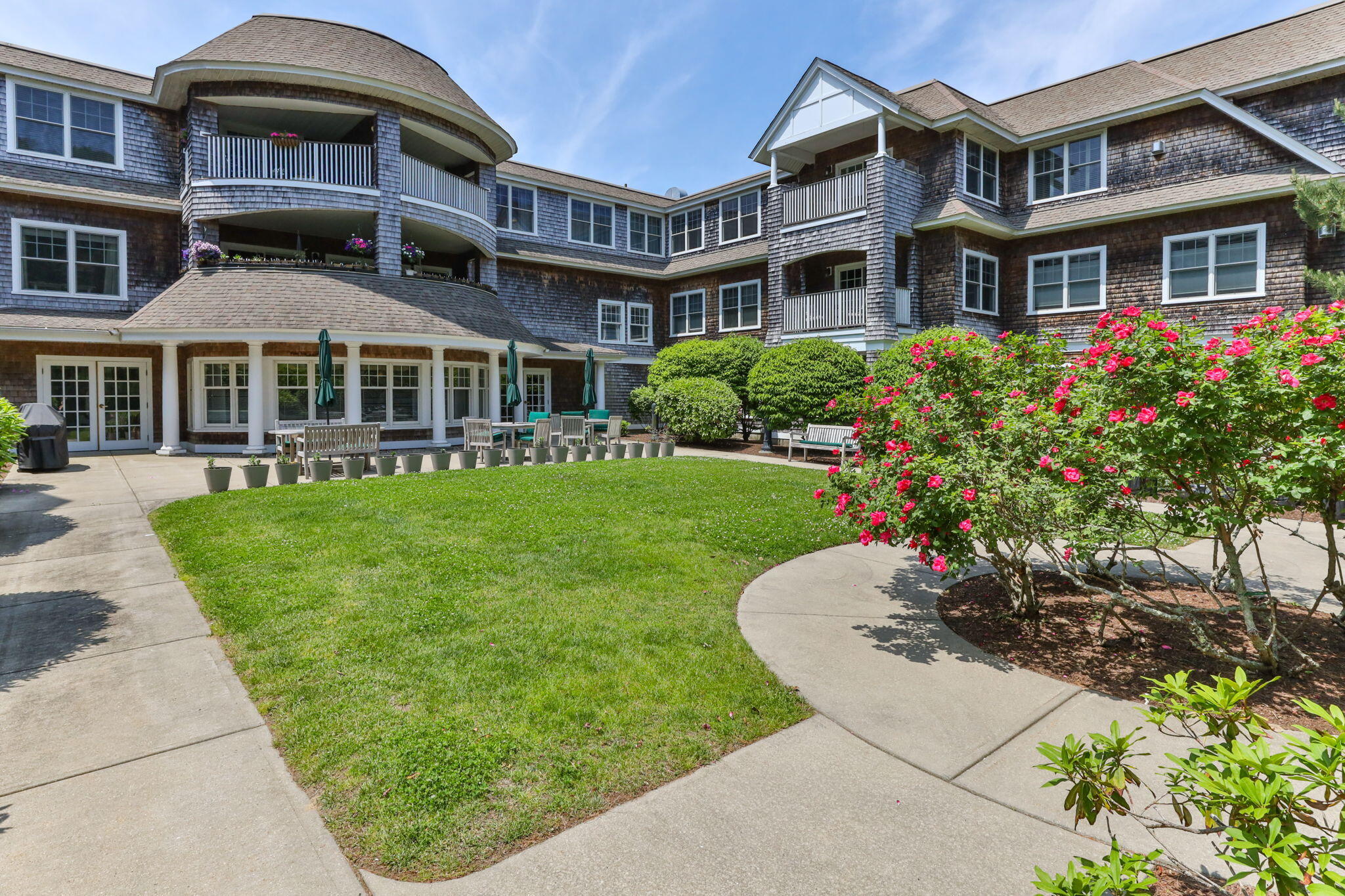 18 West Road, Unit 315 Orleans, MA 02653 - Photo 1 of 49 a front view of a building with a garden