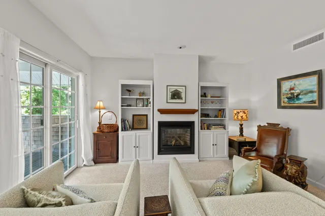 a living room with furniture flat screen tv and a fireplace