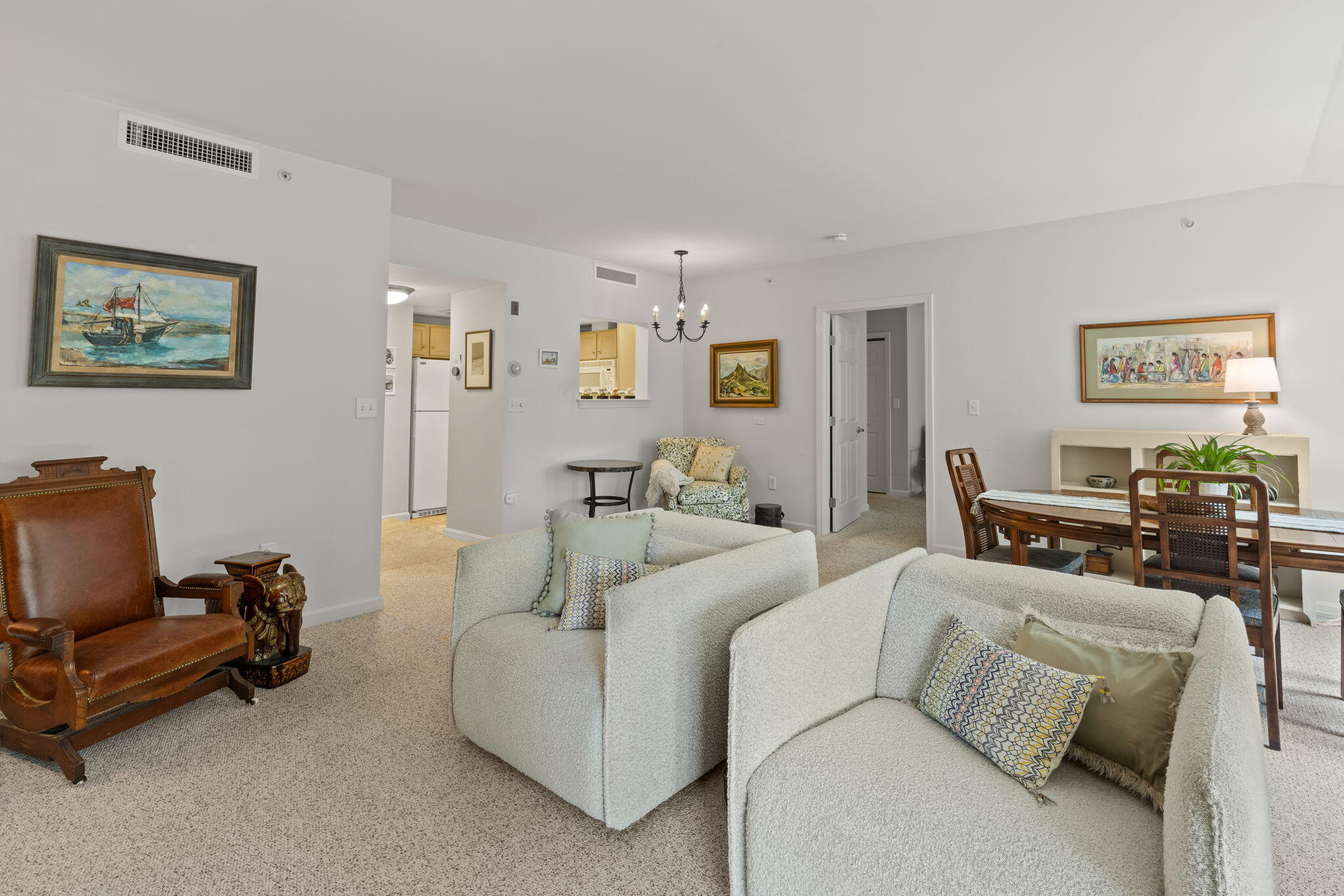 18 West Road, Unit 315 Orleans, MA 02653 - Photo 17 of 49 a living room with furniture and a view of kitchen