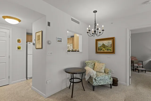 a view of a livingroom with furniture and a chandelier