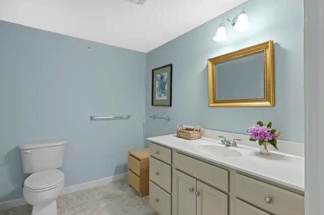 a bathroom with a toilet sink and mirror
