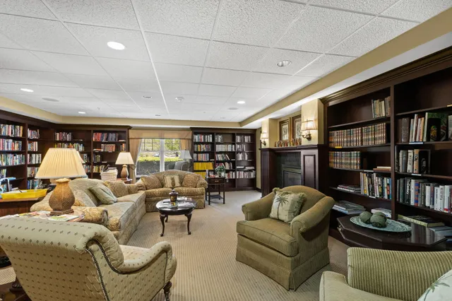 a living room with furniture and a book shelf