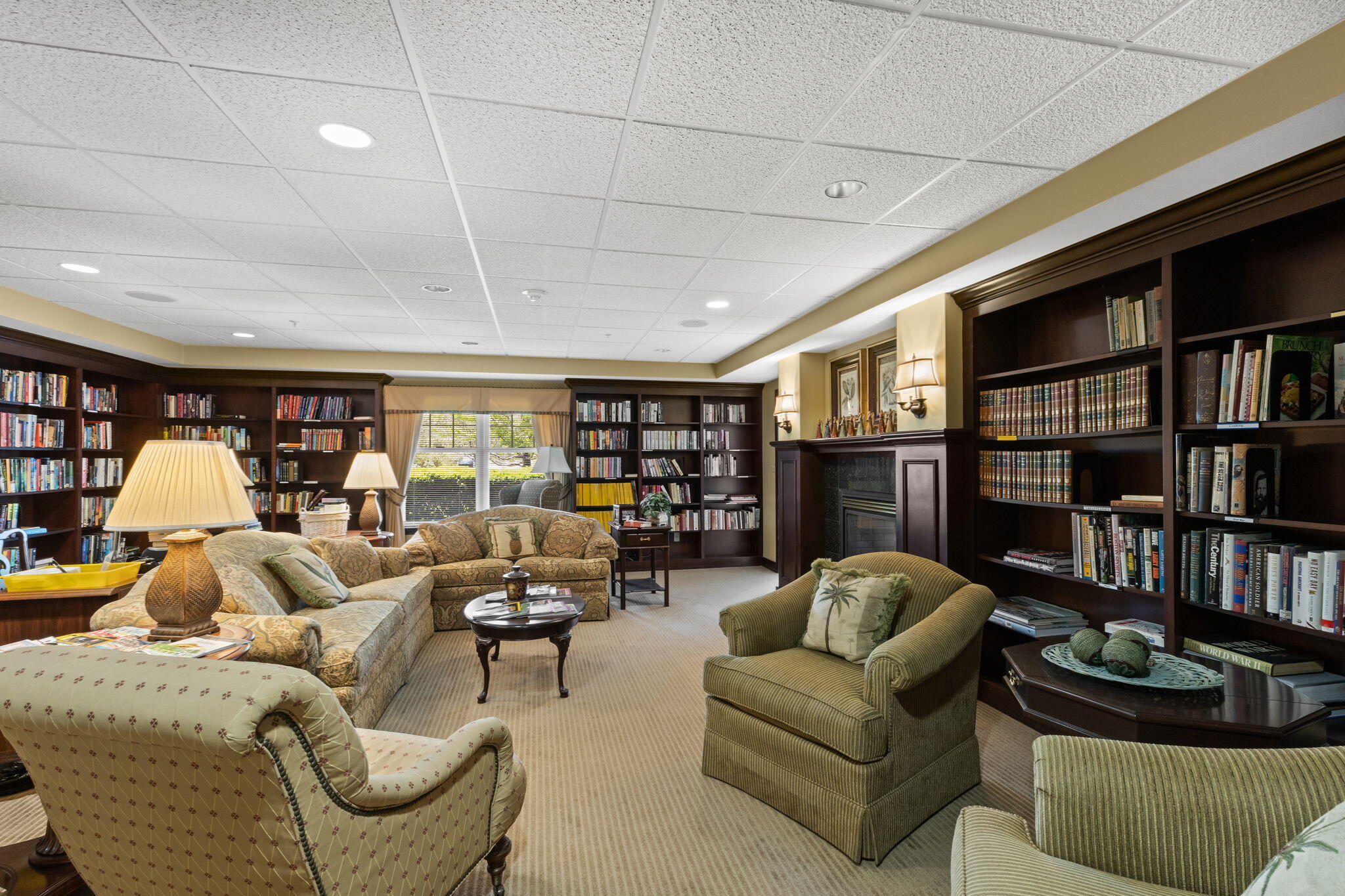 18 West Road, Unit 315 Orleans, MA 02653 - Photo 37 of 49 a living room with furniture and a book shelf
