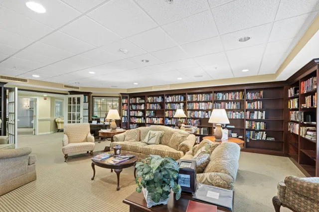 a living room with furniture and a book shelf