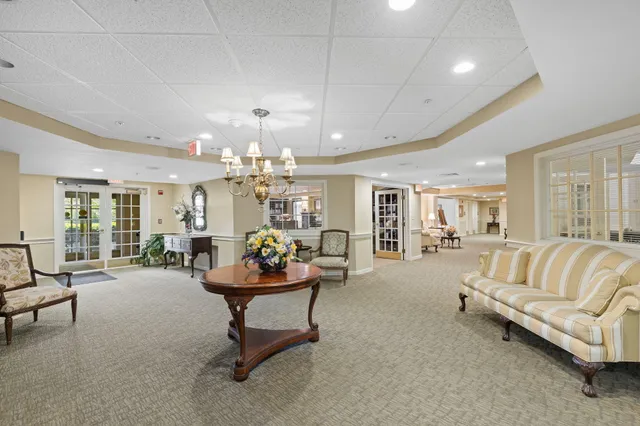 a living room with furniture and a chandelier