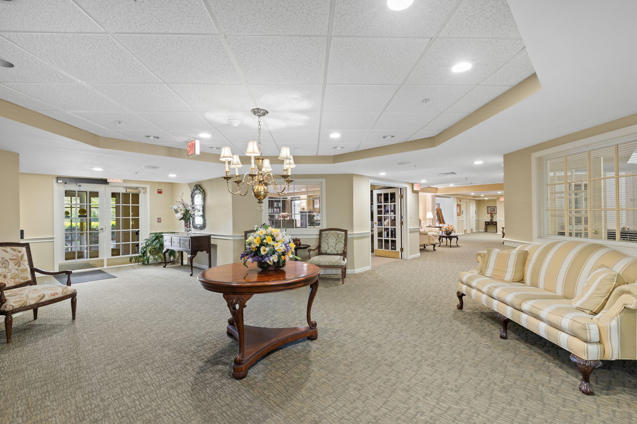 18 West Road, Unit 315 Orleans, MA 02653 - Photo 40 of 49 a living room with furniture and a chandelier
