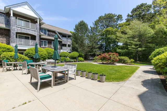 a view of a patio with a table and chairs