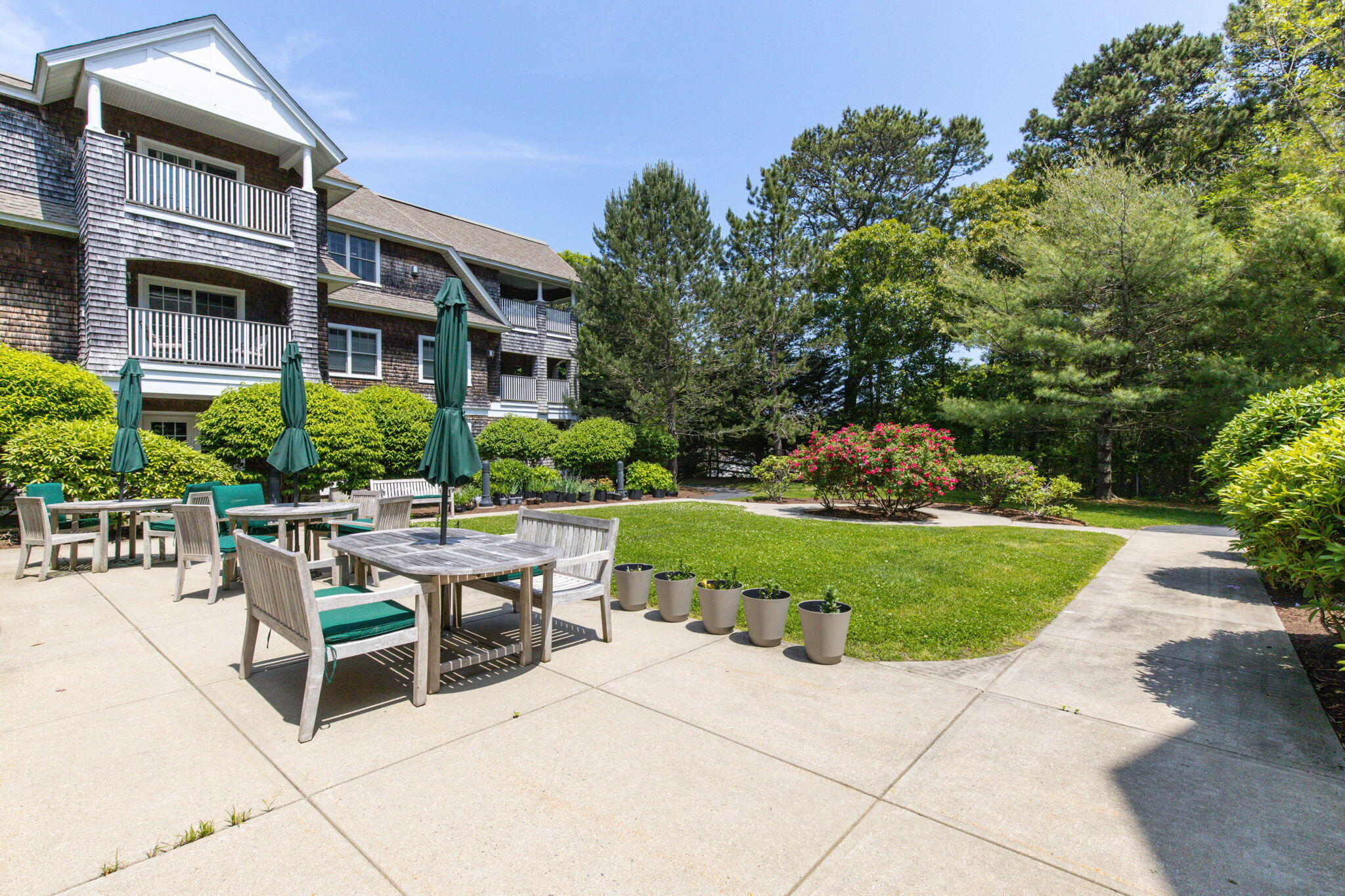 18 West Road, Unit 315 Orleans, MA 02653 - Photo 44 of 49 a view of a patio with a table and chairs