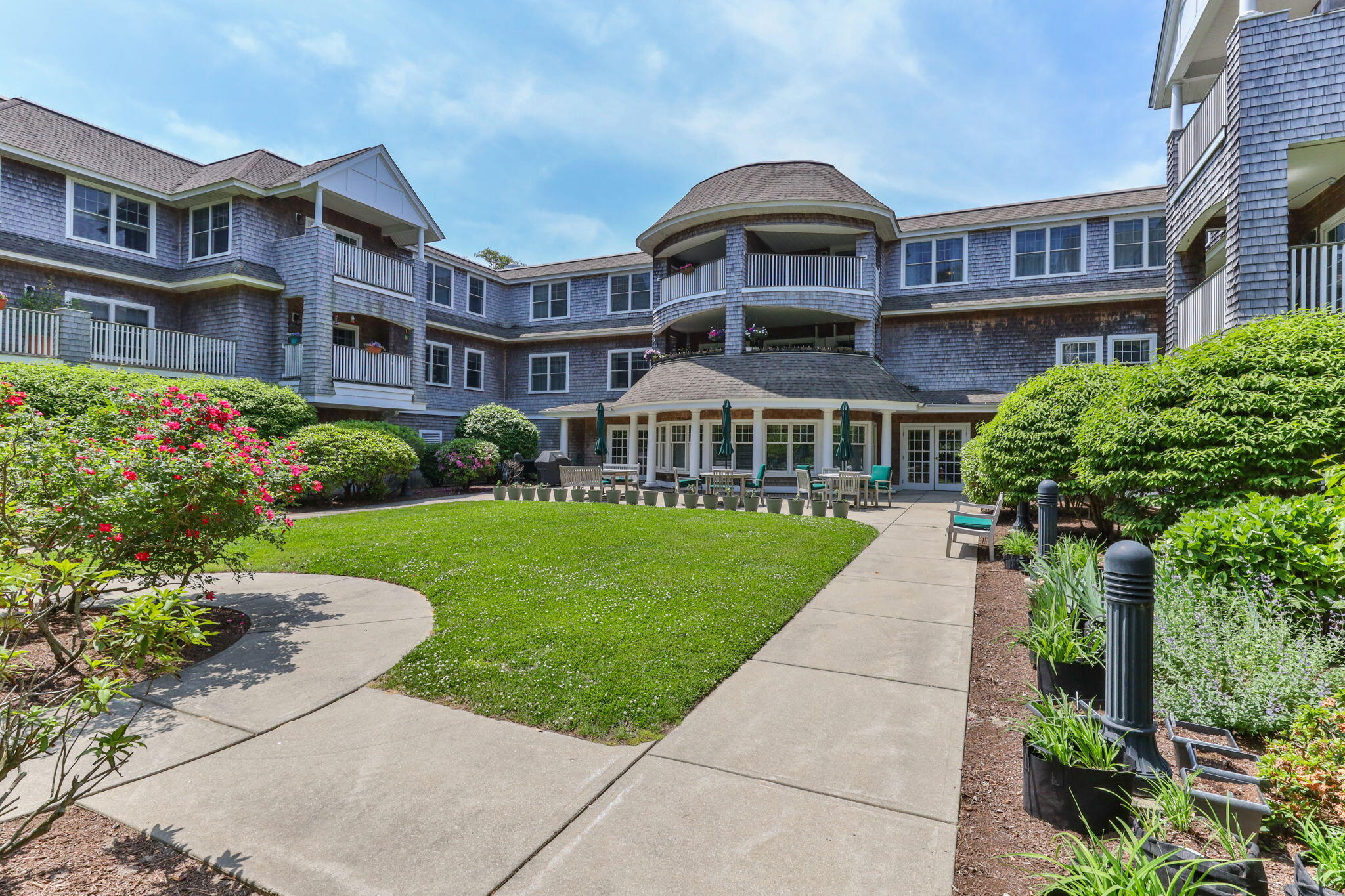 18 West Road, Unit 315 Orleans, MA 02653 - Photo 45 of 49 a front view of a building with garden