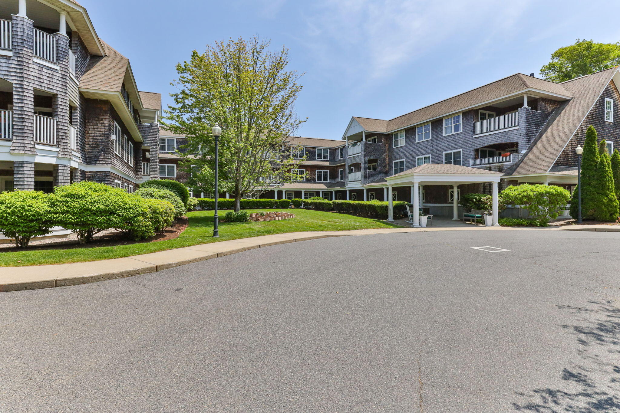 18 West Road, Unit 315 Orleans, MA 02653 - Photo 49 of 49 a view of a house with a yard and plants
