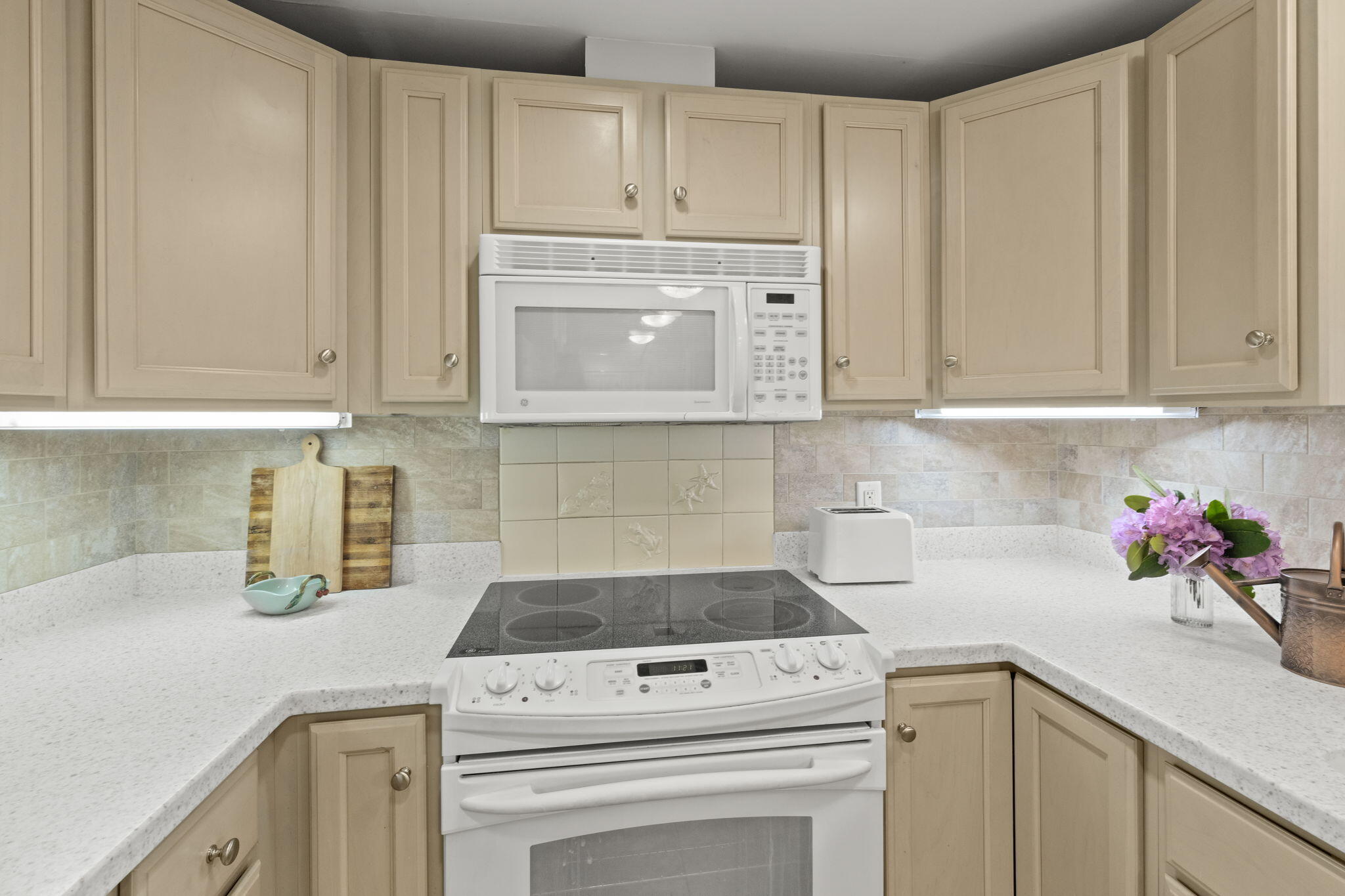 18 West Road, Unit 315 Orleans, MA 02653 - Photo 9 of 49 a kitchen with white cabinets and appliances