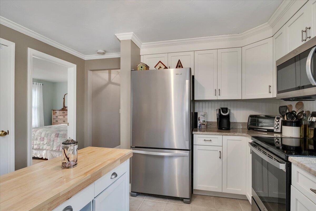 25 Christopher Hollow Road Sandwich, MA 02563 - Photo 18 of 47 a kitchen with stainless steel appliances granite countertop a refrigerator sink and white cabinets