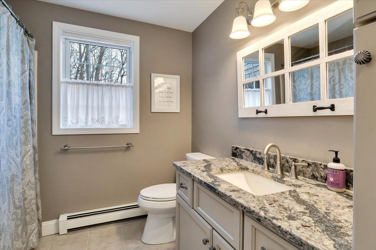 25 Christopher Hollow Road Sandwich, MA 02563 - Photo 21 of 47 a bathroom with a granite countertop sink a toilet and a window