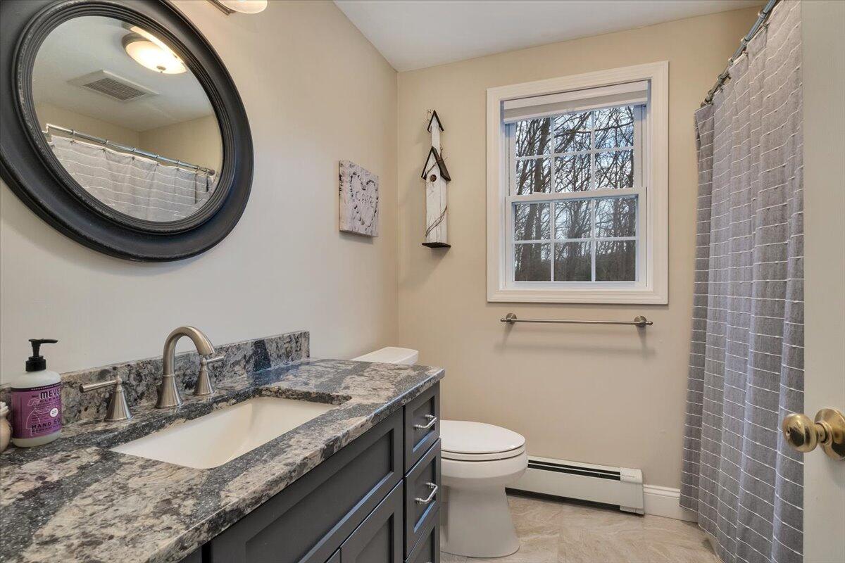 25 Christopher Hollow Road Sandwich, MA 02563 - Photo 28 of 47 a bathroom with a granite countertop toilet a sink and a mirror