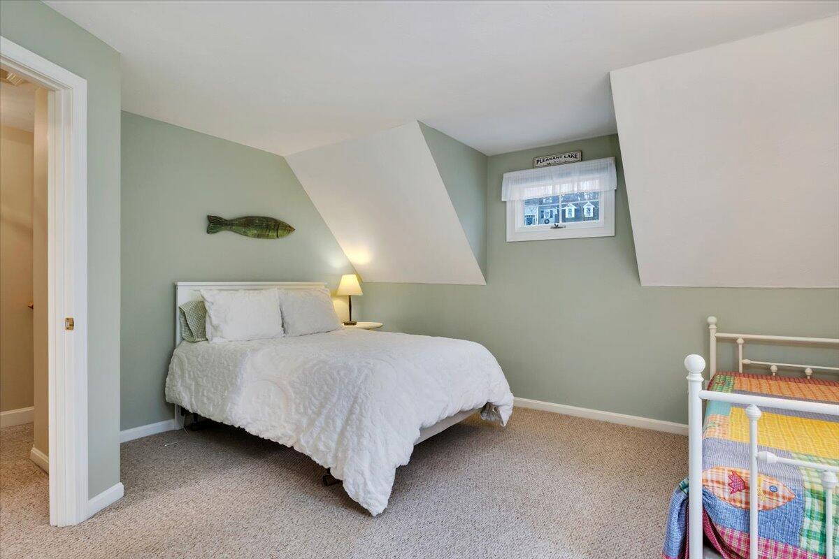 25 Christopher Hollow Road Sandwich, MA 02563 - Photo 30 of 47 a bedroom with a bed and a lamp on the dresser