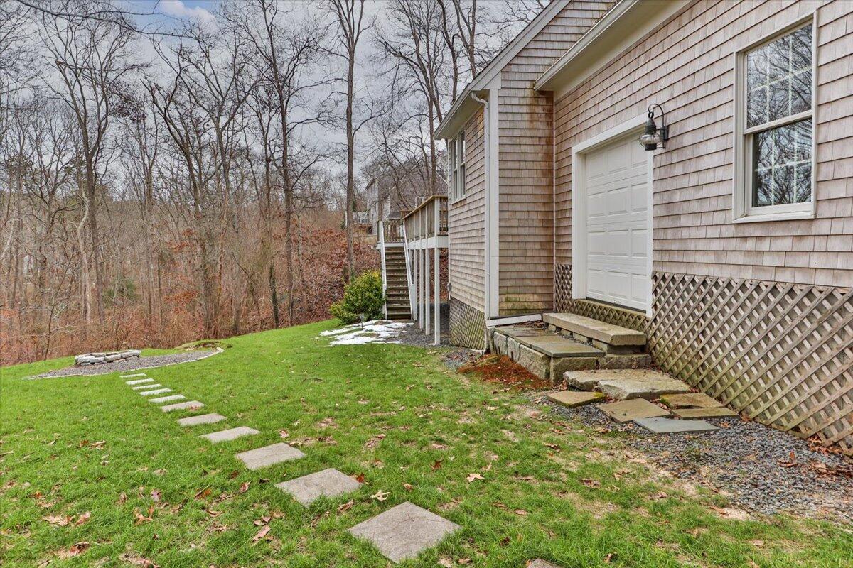 25 Christopher Hollow Road Sandwich, MA 02563 - Photo 38 of 47 a view of backyard with a table and chairs