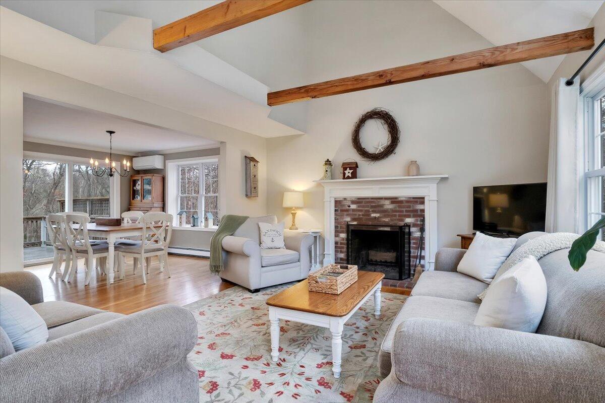 25 Christopher Hollow Road Sandwich, MA 02563 - Photo 7 of 47 a living room with furniture a fireplace and a table
