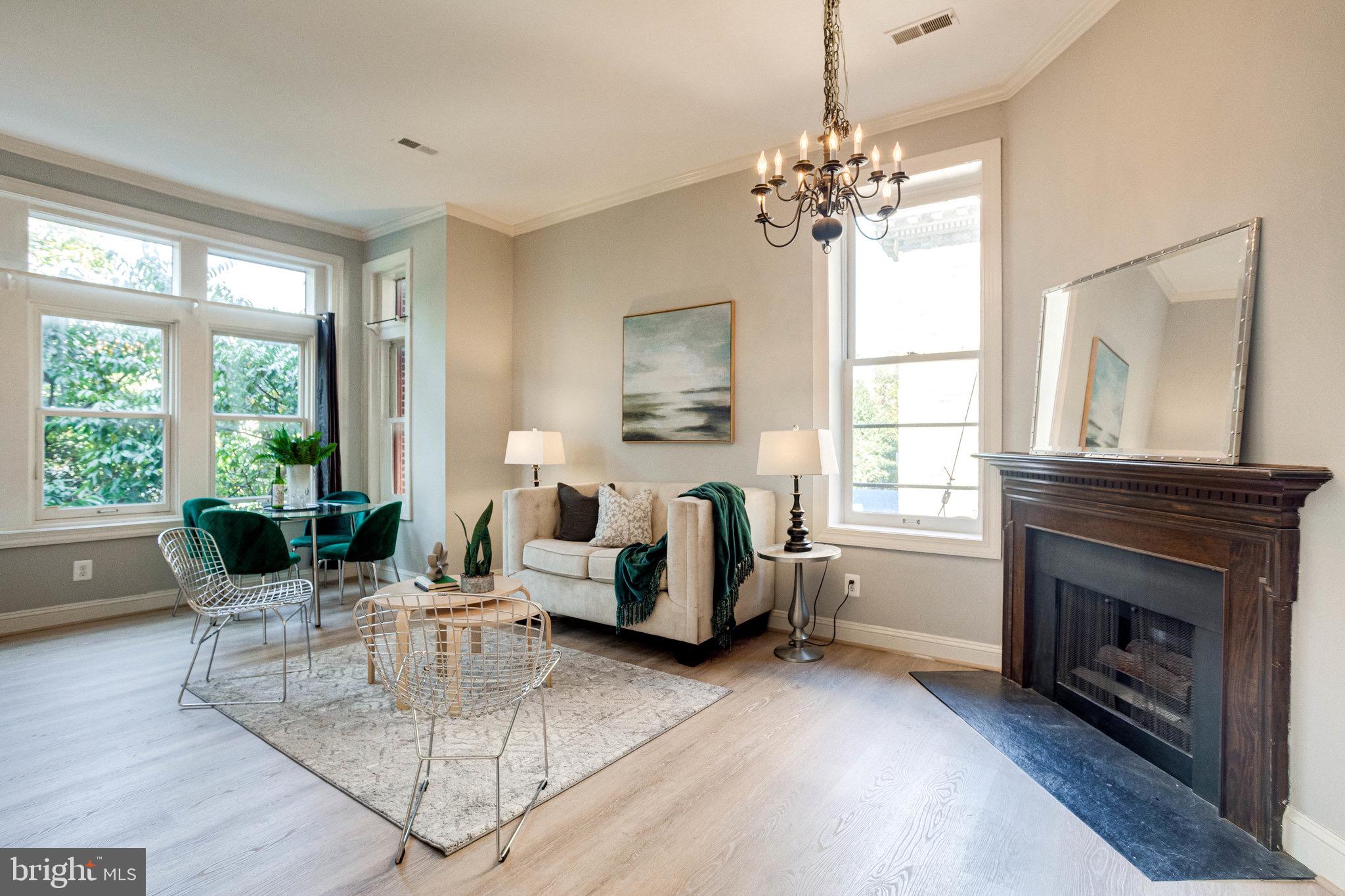 a living room with fireplace furniture and a chandelier