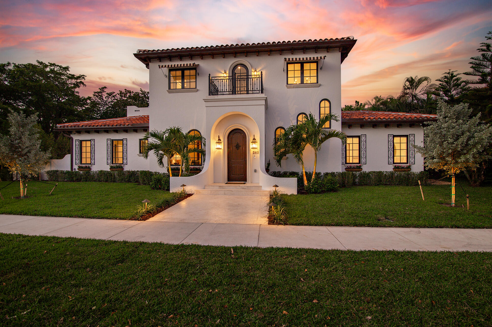 265 Marlborough Road West Palm Beach, FL 33405 - Photo 2 of 77 a front view of a house with a garden and trees