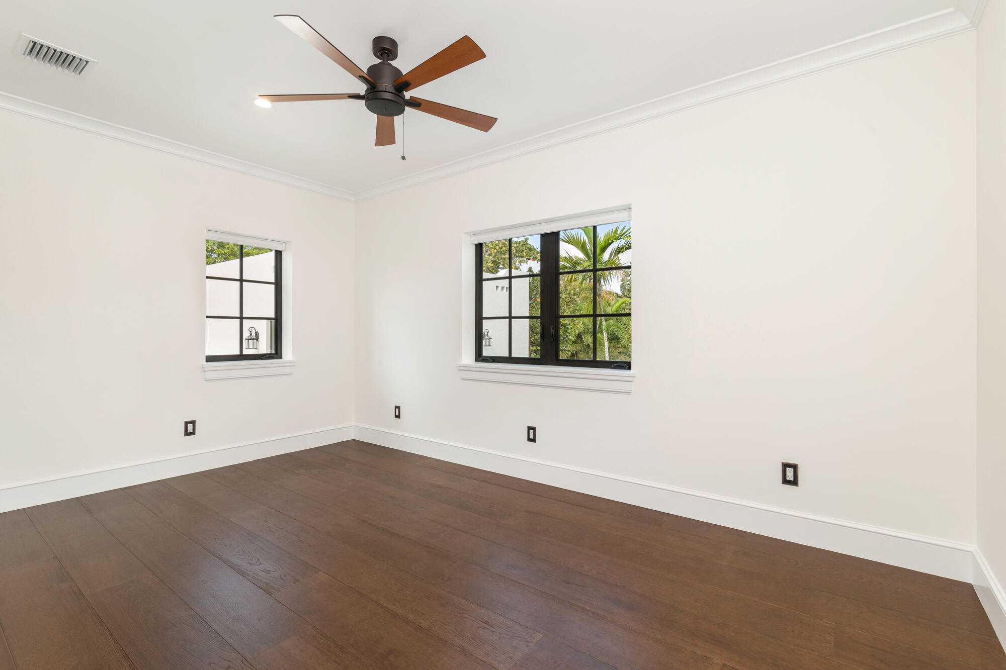 265 Marlborough Road West Palm Beach, FL 33405 - Photo 47 of 77 an empty room with wooden floor ceiling fan and windows