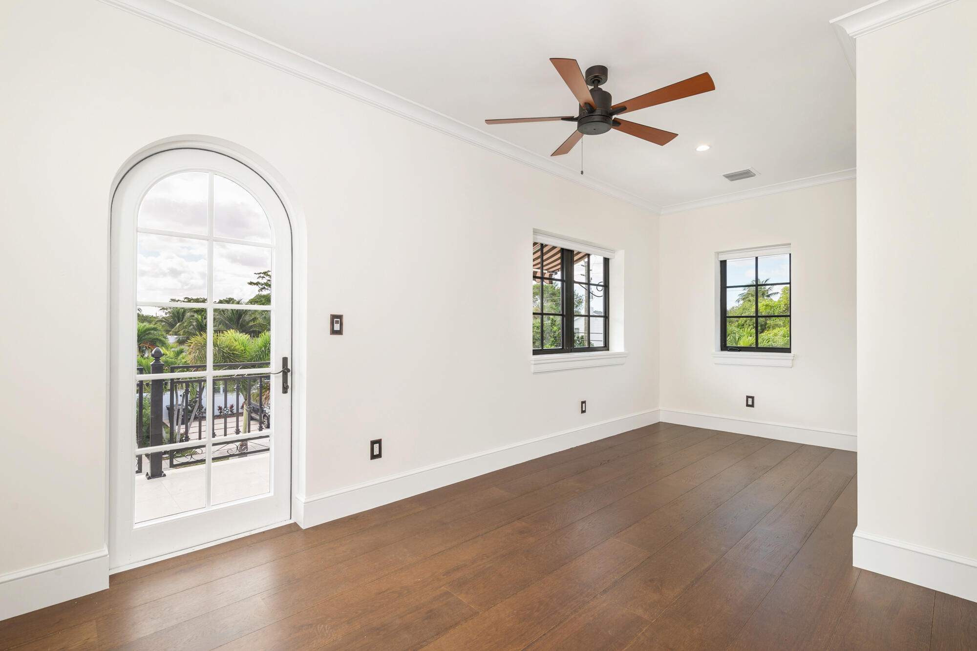 265 Marlborough Road West Palm Beach, FL 33405 - Photo 52 of 77 an empty room with wooden floor a ceiling fan and windows