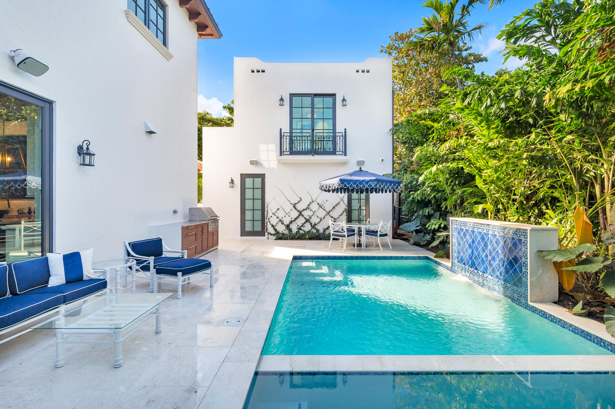 265 Marlborough Road West Palm Beach, FL 33405 - Photo 65 of 77 a view of a patio with table and chairs potted plants and a large tree
