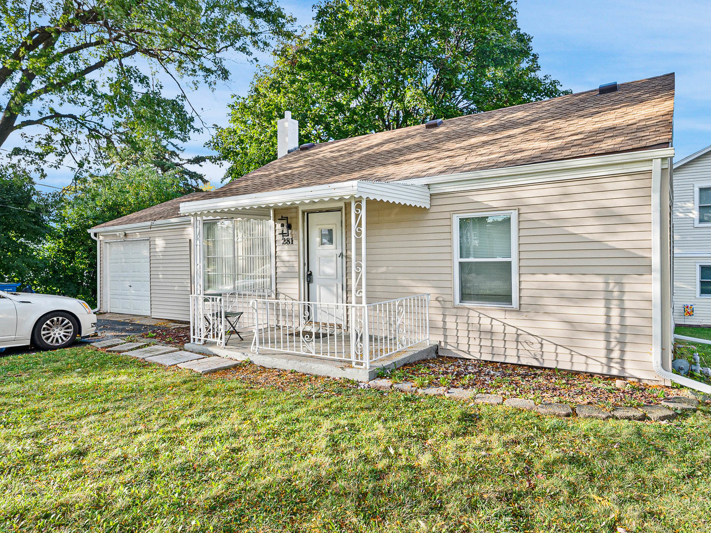 a view of a house with backyard and sitting area
