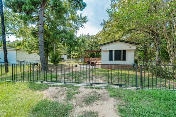 a view of a house with a yard and plants