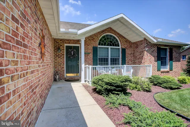 a view of a brick house with large windows