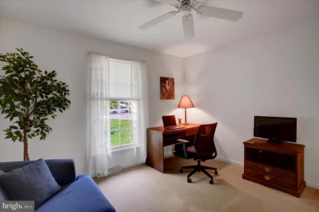 a bedroom with a bed and a lamp on dresser