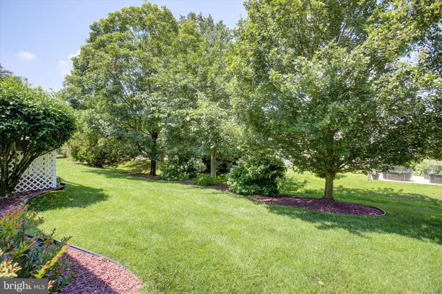 a view of a house with backyard and a garden
