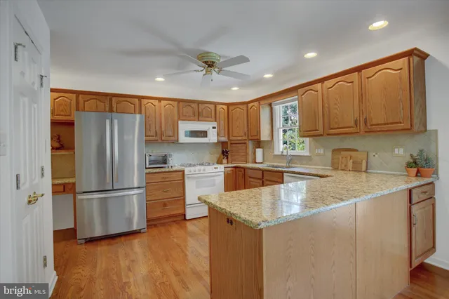 a kitchen with granite countertop a counter space stainless steel appliances and cabinets