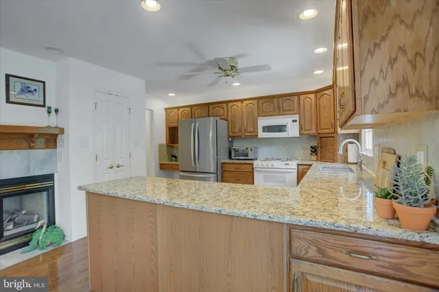 a kitchen with stainless steel appliances granite countertop a refrigerator sink and cabinets