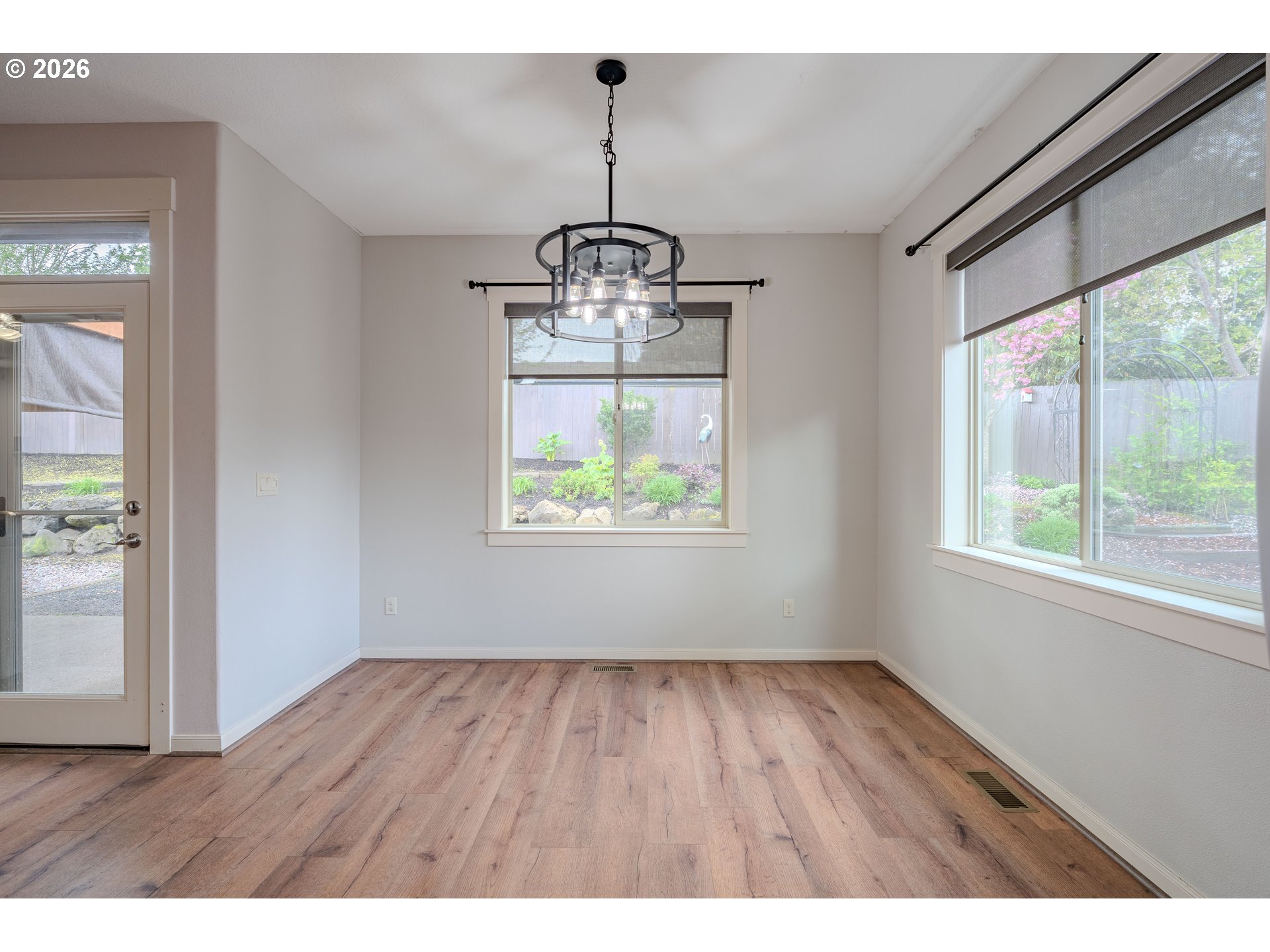 2156 Southwest 14th Drive Gresham, OR 97080 - Photo 12 of 48 a view of an empty room with wooden floor and a window