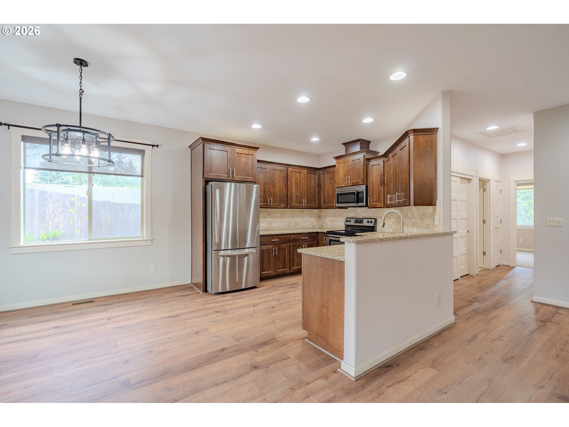 2156 Southwest 14th Drive Gresham, OR 97080 - Photo 8 of 48 a kitchen with stainless steel appliances granite countertop a refrigerator a sink dishwasher a stove and a wooden cabinets