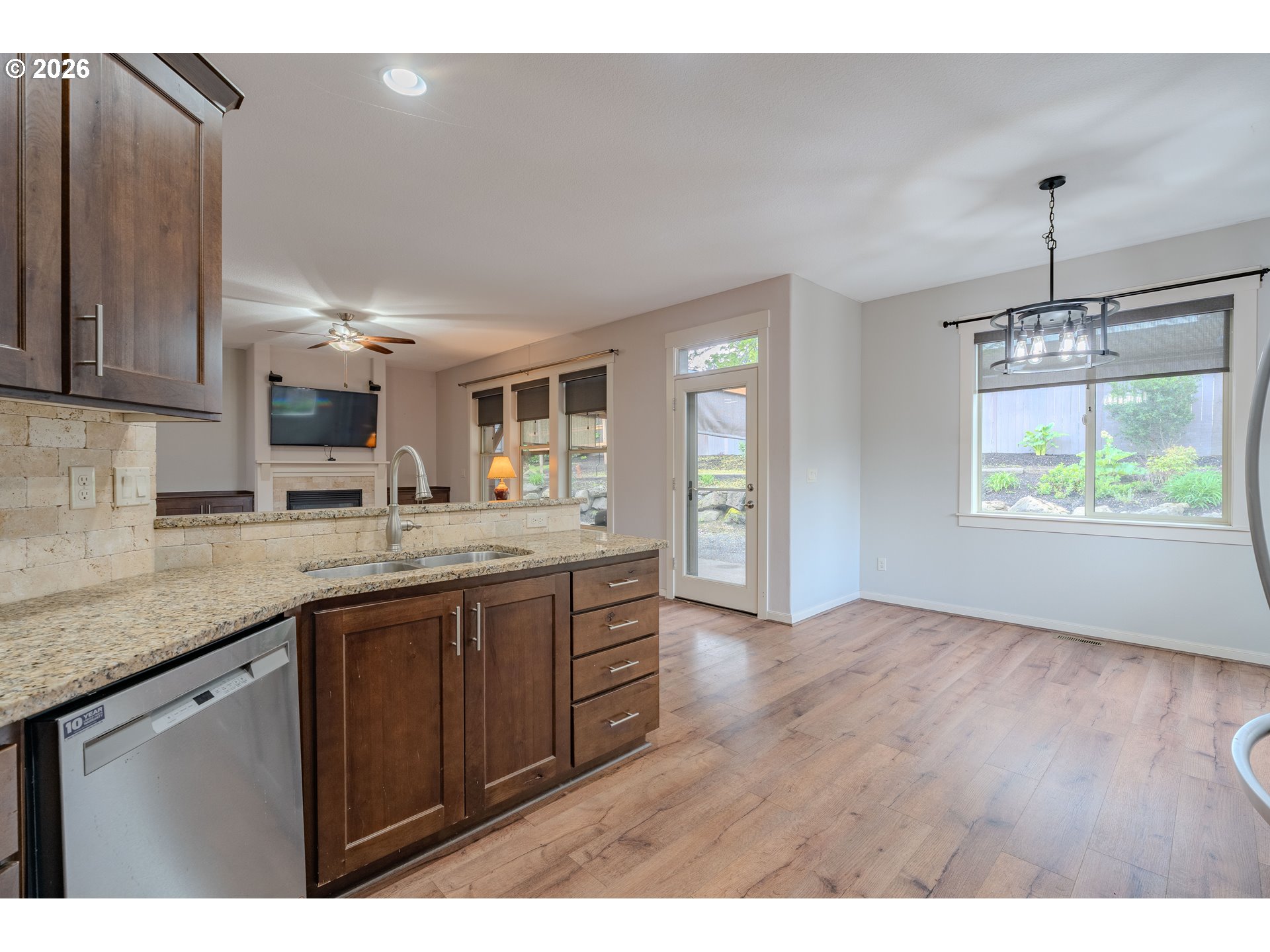 2156 Southwest 14th Drive Gresham, OR 97080 - Photo 10 of 48 a kitchen with kitchen island granite countertop a sink window and cabinets