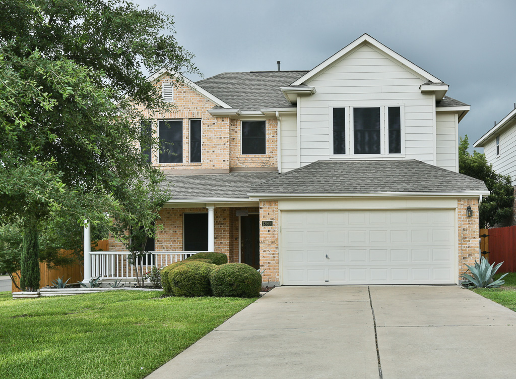 a front view of house with yard and green space