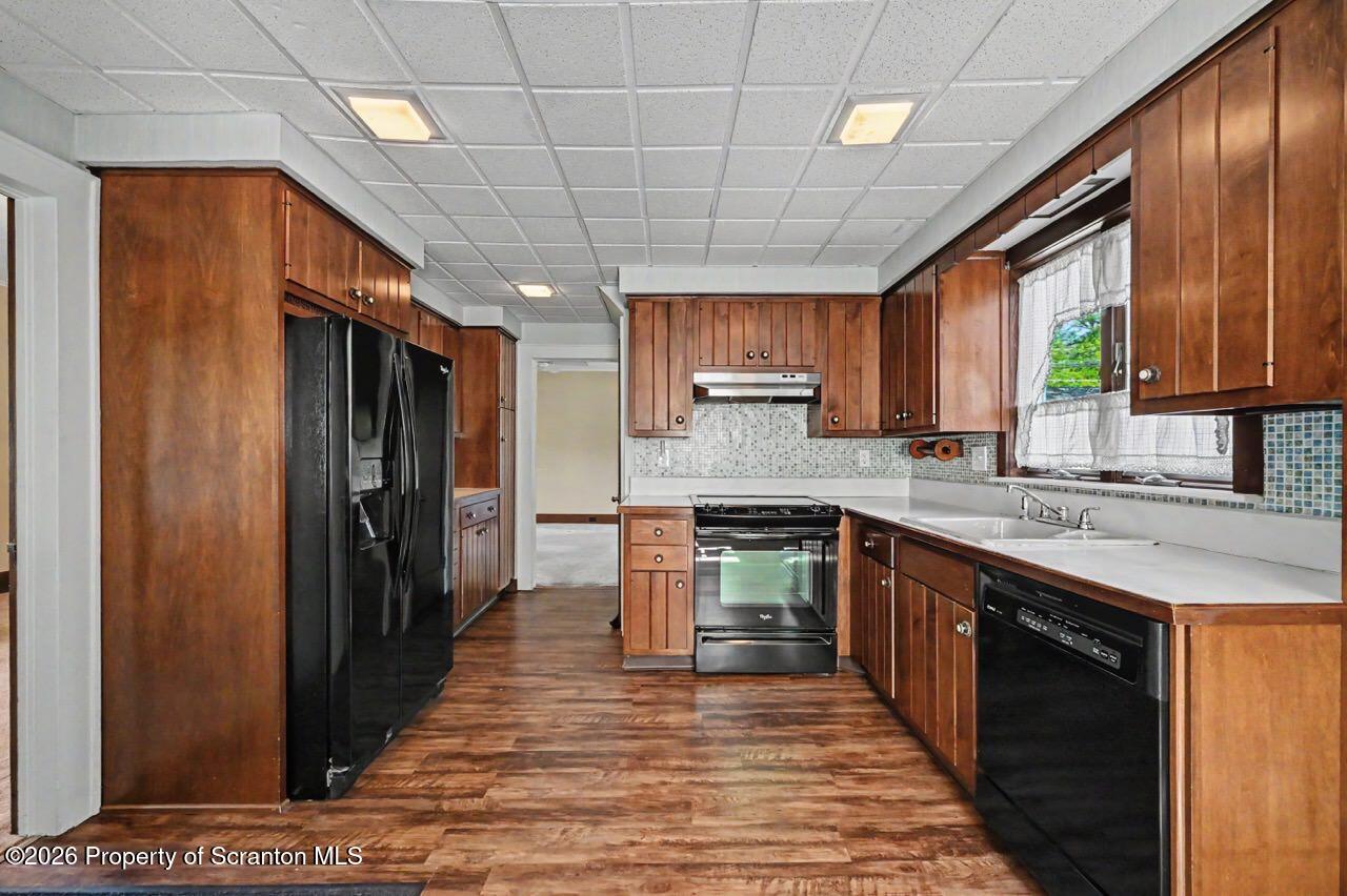 502 Layton Road Clarks Summit, PA 18411 - Photo 18 of 42 a kitchen with stainless steel appliances granite countertop a sink stove refrigerator and cabinets