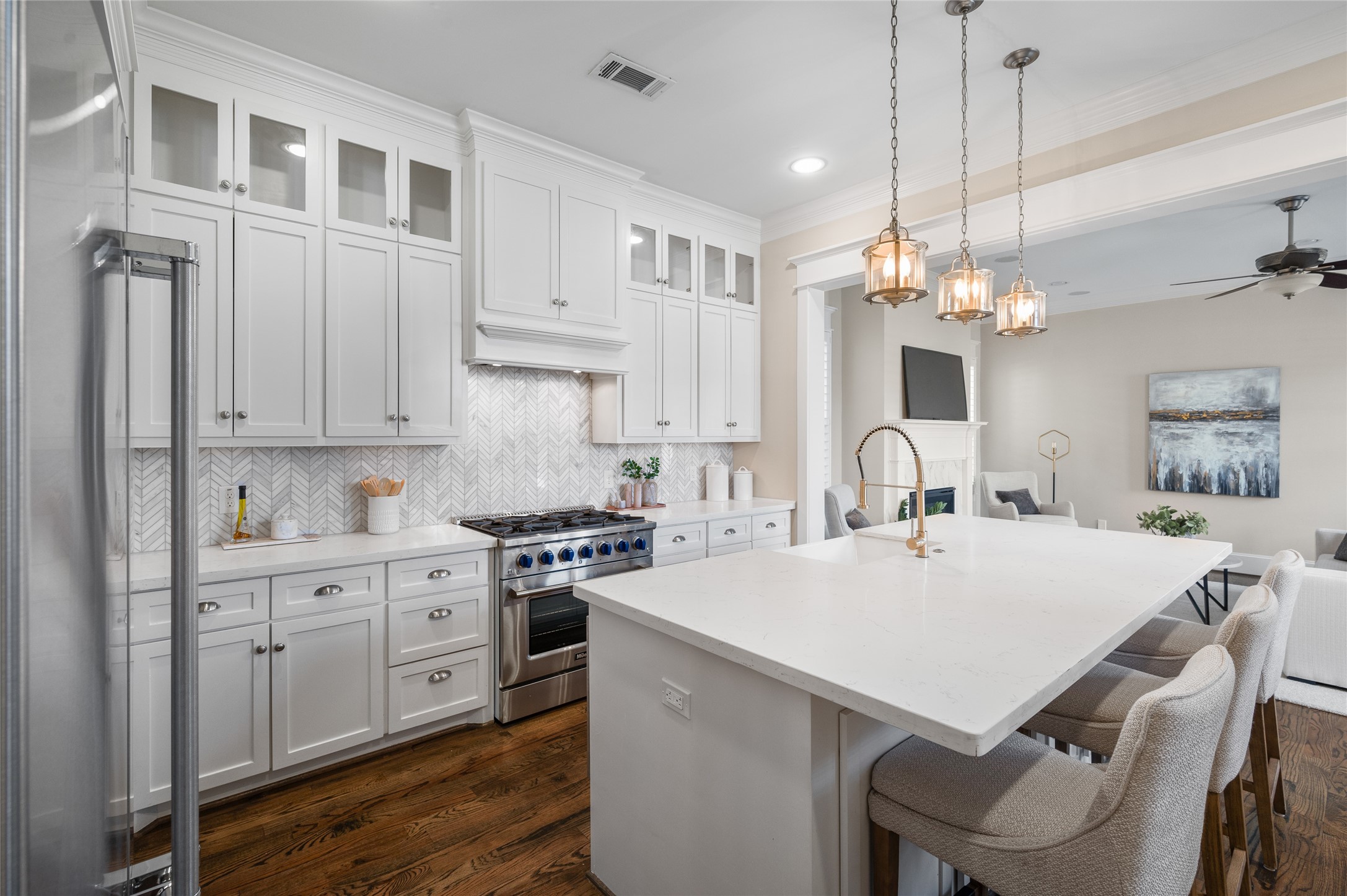 1003 East 25th Street Houston, TX 77009 - Photo 10 of 33 Bright and airy chef’s kitchen featuring clean white cabinetry, a large quartz island perfect for meal prep or entertaining, and sleek modern finishes